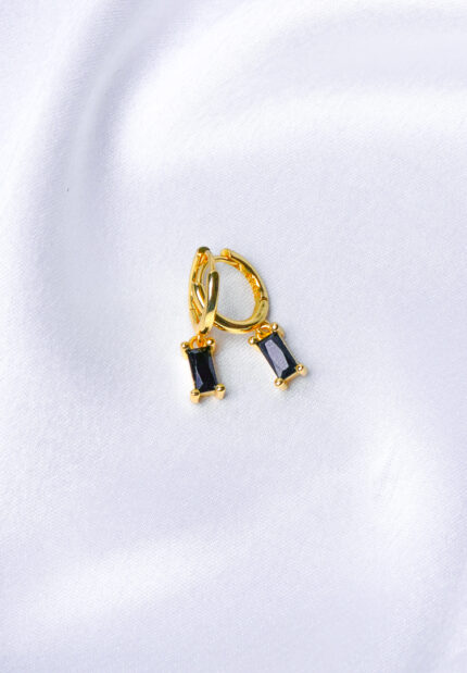 Dainty gold-tone huggie hoop earring with a dangling clear rectangular-cut gemstone and a secure lever-back clasp