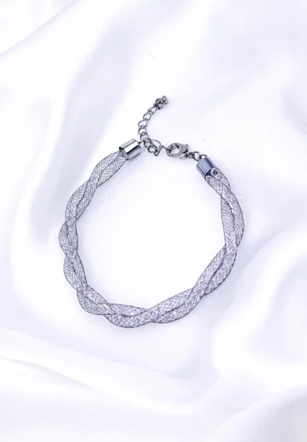 Refined and lightweight interwoven metal wire bracelet with shimmering crystals inside, secured with a lobster clasp for a secure fit.