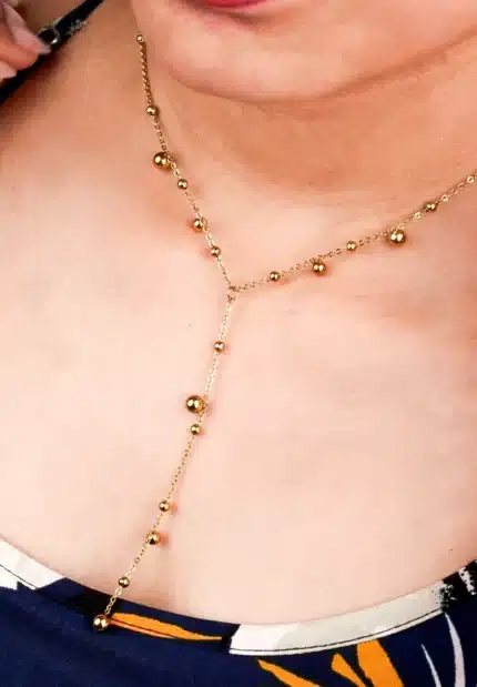 Sophisticated gold-tone lariat necklace with a satellite chain structure, round bead accents, and a secure lobster clasp closure.