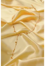 Sophisticated gold-tone lariat necklace with a satellite chain structure, round bead accents, and a secure lobster clasp closure.