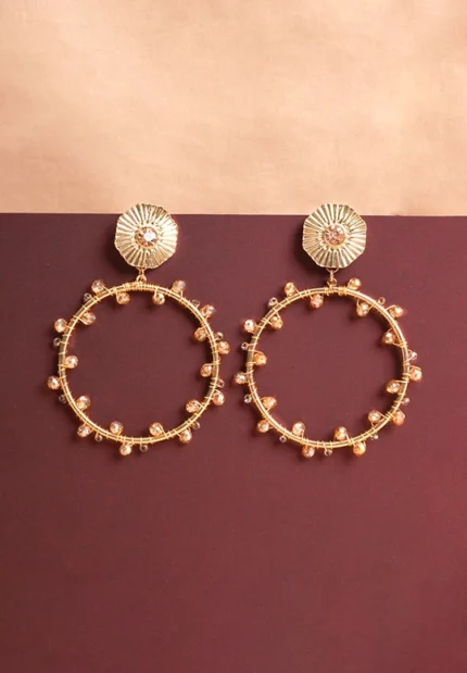 Chic octagonal hoop earrings featuring a polished gold-tone finish, playful blue gemstone ,colorful beaded accents, and a push back for easy wear.