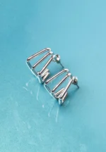 Chic metal hoop earrings featuring a polished silver-tone finish, playful geometric cage, and a push back for easy wear.