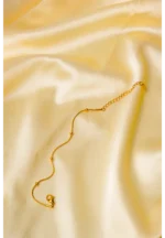 Polished gold-tone snake chain bracelet featuring evenly spaced small circular beads and a secure lobster claw clasp
