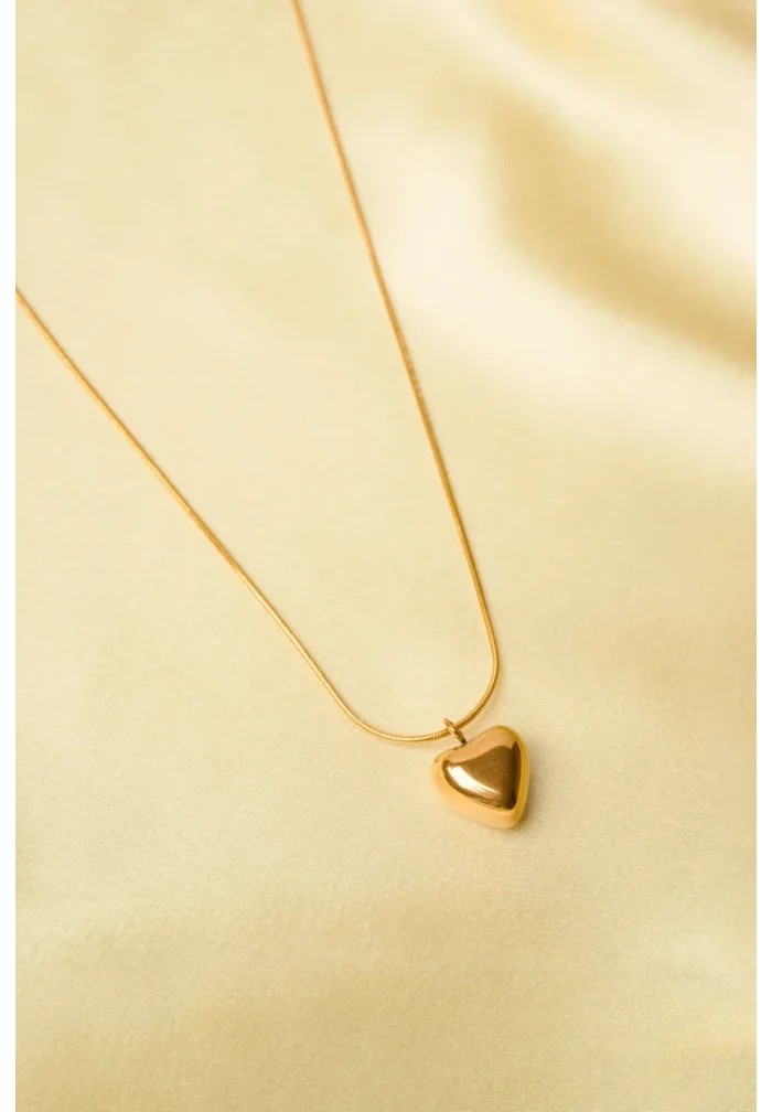 Trendy gold-tone rope chain necklace with a circular pendant, elegantly designed with a glittery silver inlay and a rose engraving, secured with a lobster claw clasp.