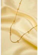 Minimalist gold-tone bracelet with a fine satellite chain, a sleek curved rectangular bar, and a petite orange heart charm, finished with a secure lobster claw clasp.