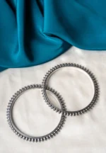 Antique-inspired oxidized silver-tone bangle set with finely detailed lines and circular metallic beaded designs.