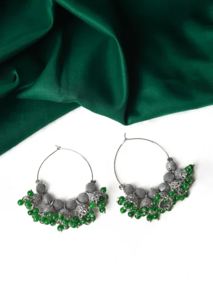 Classic silver-tone hoop earring designed with circular beads, dangling jhumkas, and small bead embellishments at the edges for a traditional appeal.