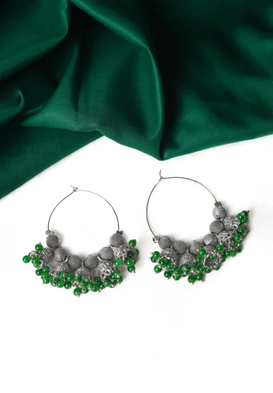 Classic silver-tone hoop earring designed with circular beads, dangling jhumkas, and small bead embellishments at the edges for a traditional appeal.