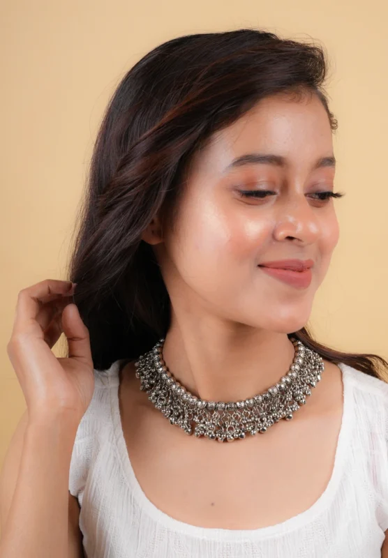 Timeless oxidized silver-tone curb chain necklace adorned with circular beads and tiny ghungroos, finished with a sturdy lobster clasp for a secure fit.