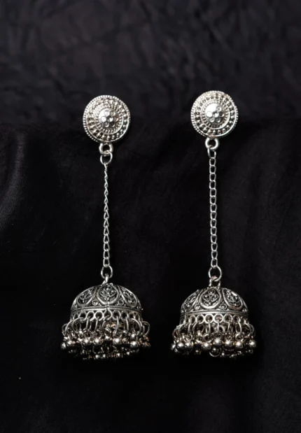 Traditional oxidized silver jhumka earring featuring fine intricate detailing, a floral-designed top, and a secure push-back closure.