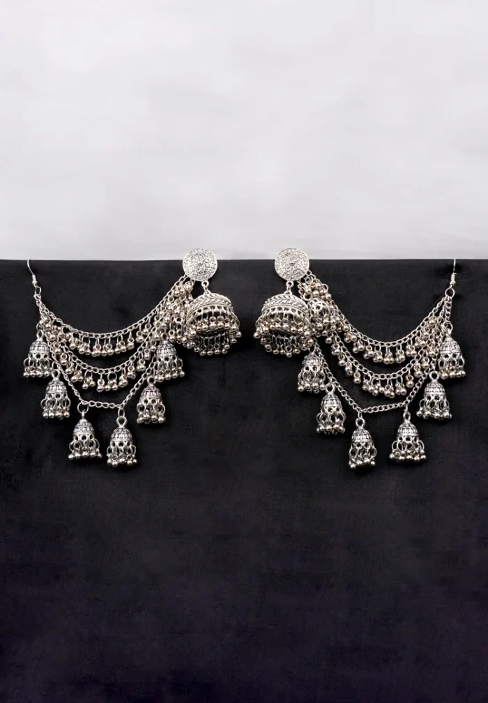 Antique-style silver-tone jhumka ear hair chain earring featuring a floral-detailed circular top, cascading chain tassels with ghungroos and miniature jhumkas, finished with a push-back and French hook closure.