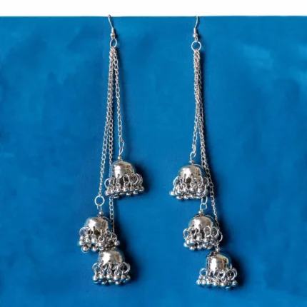 Statement oxidized silver tone tassel earrings featuring a delicately engraved long vrying jhumkas,ghungroos at the end, and finished with a push-back closure.