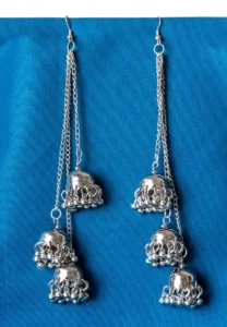 Statement oxidized silver tone tassel earrings featuring a delicately engraved long vrying jhumkas,ghungroos at the end, and finished with a push-back closure.