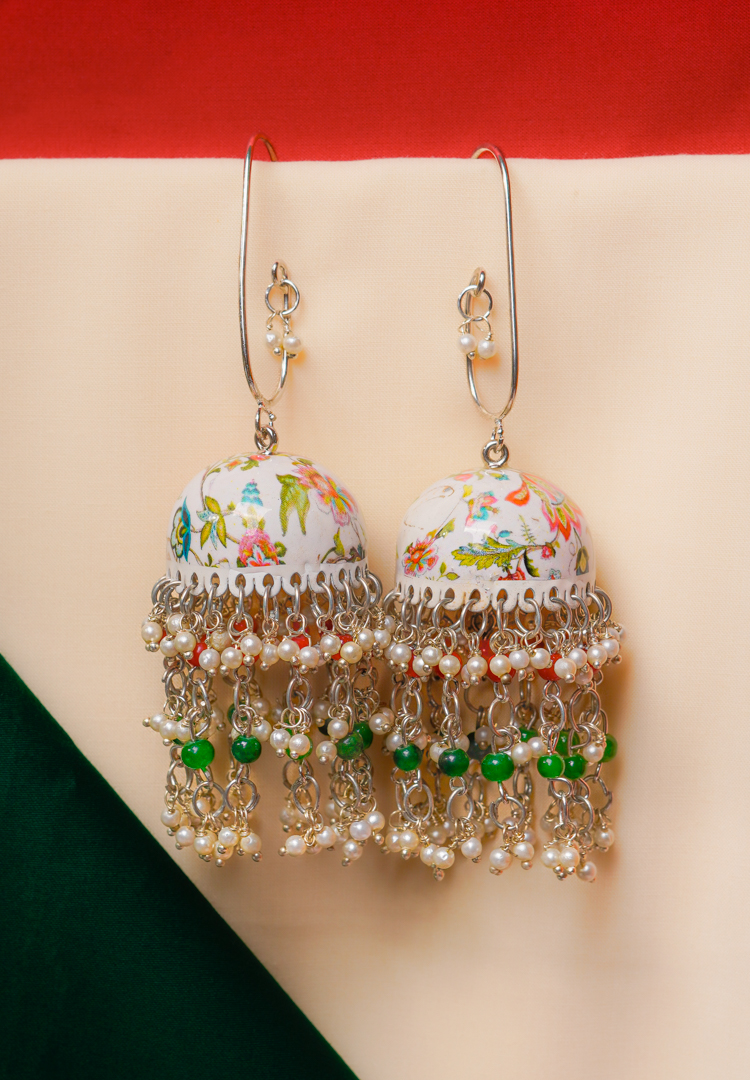 364-Th Fusion-style silver-tone jhumka earring featuring intricate floral meenakari artwork,fine chain tassels, and red and green pearl bead embellishments and a curved hook closure