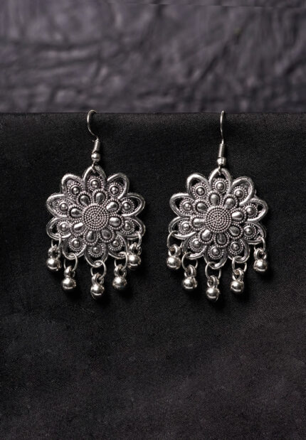 Statement oxidized silver floral drop earring showcasing fine detailing, dangling ghungroos, and a secure French hook closure