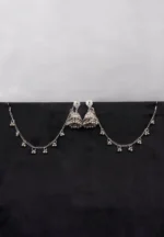 Antique-style silver-tone jhumka ear hair chain earring featuring teadrop top, a chain tassel detailed with pearl beads and a delicate chain with circular line charms, finished with a push-back closure, with ghungroos at the end with a curved hook closure.