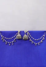 Antique-style silver-tone jhumka ear hair chain earring featuring teadrop top, triangular jhumkas having chain tassel detailed with pearl beads and a delicate chain with circular line charms, finished with a push-back closure, with ghungroos at the end with a curved hook closure.