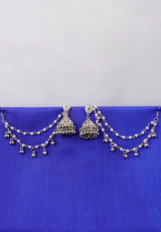 Antique-style silver-tone jhumka ear hair chain earring featuring teadrop top, triangular jhumkas having chain tassel detailed with pearl beads and a delicate chain with circular line charms, finished with a push-back closure, with ghungroos at the end with a curved hook closure.