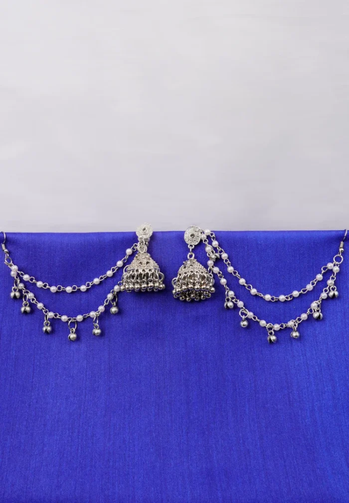 Antique-style silver-tone jhumka ear hair chain earring featuring teadrop top, triangular jhumkas having chain tassel detailed with pearl beads and a delicate chain with circular line charms, finished with a push-back closure, with ghungroos at the end with a curved hook closure.