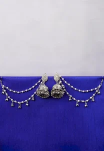 Antique-style silver-tone jhumka ear hair chain earring featuring teadrop top, a chain tassel detailed with pearl beads and a delicate chain with circular line charms, finished with a push-back closure, with ghungroos at the end with a curved hook closure.