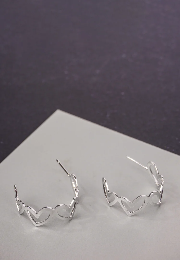 _DSC2810 Trendy mini C-hoop earring with a polished silver-tone, heart shapded and , push-back post.