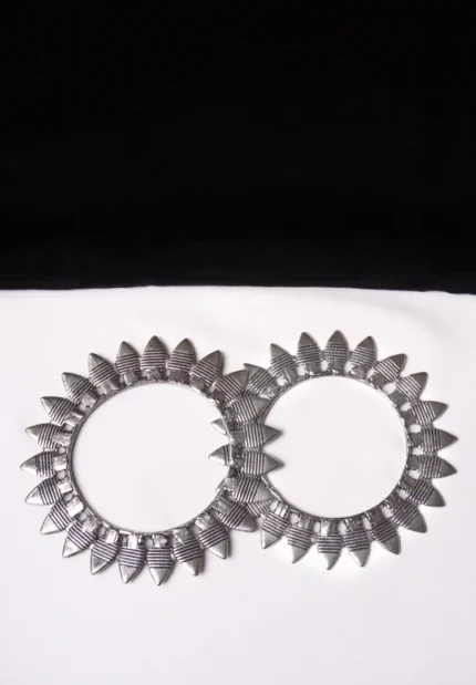 Antique-inspired oxidized silver-tone bangle set with finely detailed lines and geometric triangular cone structures.