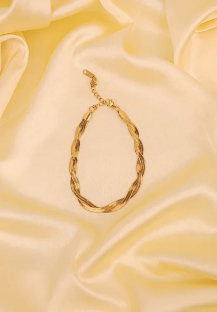 Elegant adjustable curb chain bracelet in a gold-tone finish, featuring a curved metallic wire centerpiece with a dangling spherical charm and a secure spring ring clasp.