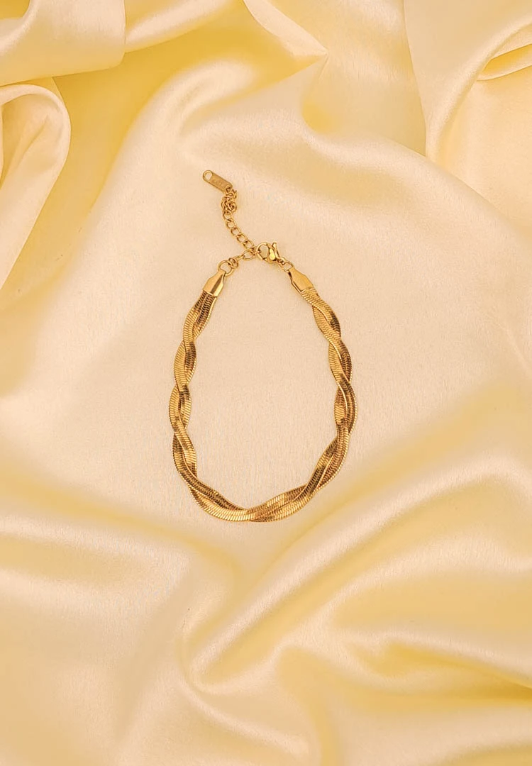 th (66) Elegant adjustable curb chain bracelet in a gold-tone finish, featuring a curved metallic wire centerpiece with a dangling spherical charm and a secure spring ring clasp.