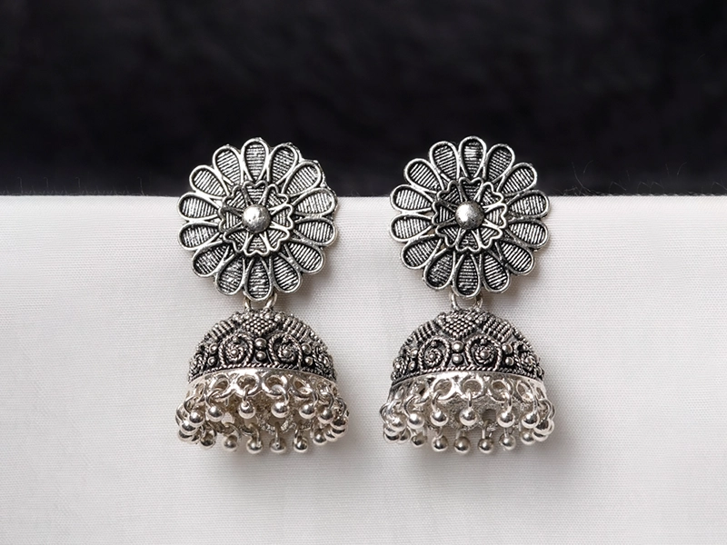Elegant flatlay of oxidised jewelry including layered necklaces, jhumkas, bangles, and rings styled with ethnic and Western outfits – perfect for every occasion 13
