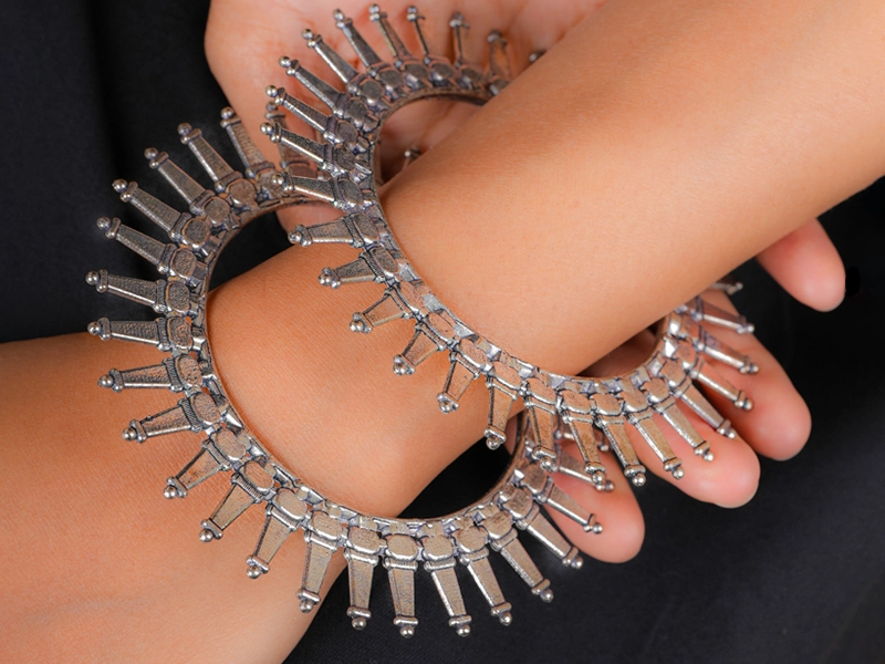 Elegant flatlay of oxidised jewelry including layered necklaces, jhumkas, bangles, and rings styled with ethnic and Western outfits – perfect for every occasion2