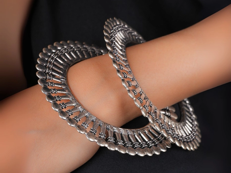 Elegant flatlay of oxidised jewelry including layered necklaces, jhumkas, bangles, and rings styled with ethnic and Western outfits – perfect for every occasion 11