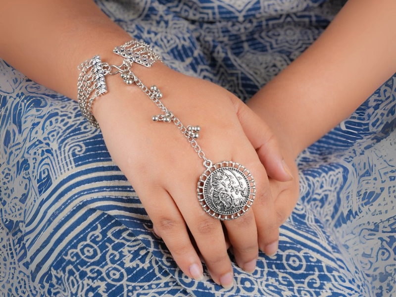 Elegant flatlay of oxidised jewelry including layered necklaces, jhumkas, bangles, and rings styled with ethnic and Western outfits – perfect for every occasion 12