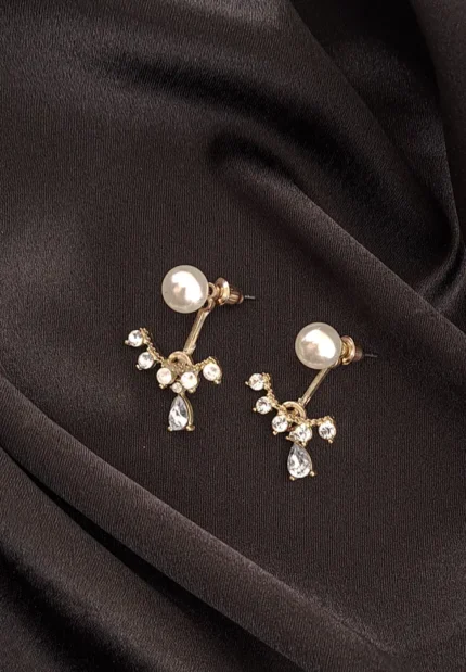 Gold-toned pearl stud earring with floral crystal design and teardrop stone