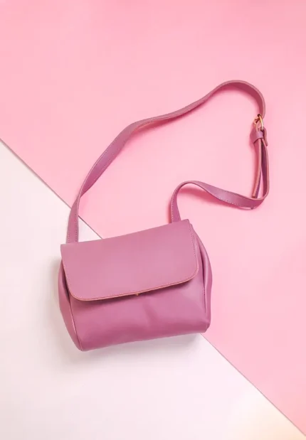lavender sling bag with curved flap and adjustable strap, featuring a sleek minimalist design — perfect for everyday style.