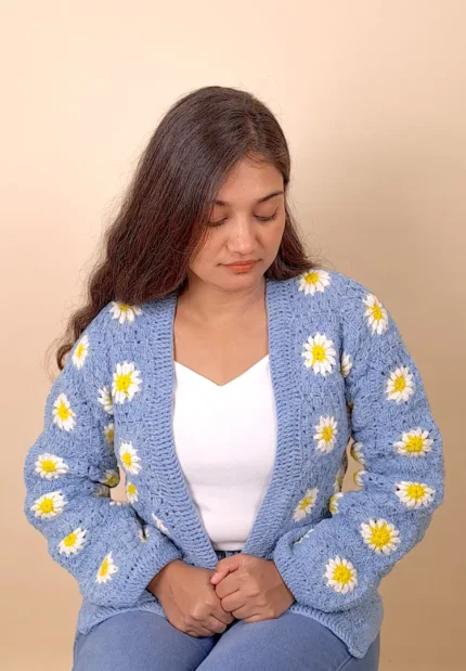 Light blue crochet cardigan featuring delicate blossom-style detailing.