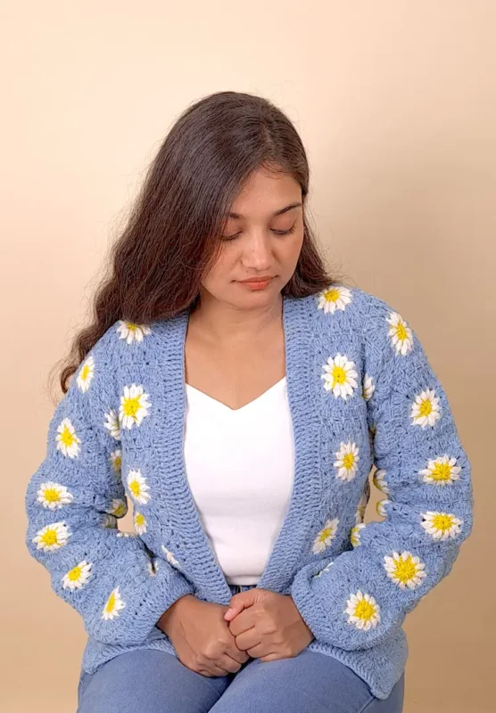 Light blue crochet cardigan featuring delicate blossom-style detailing.