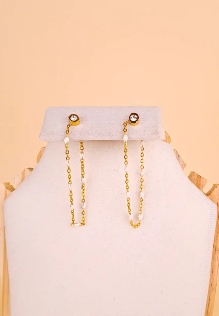 Gold drop earring featuring tiny white beads and a crystal top.