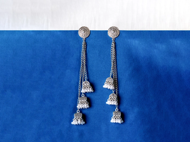 Earring styling featuring statement long drops for party looks