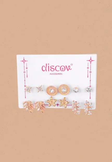 Collection of five pairs of gold-toned stud earrings, including bow shapes, textured flower studs, simple pearl domes, tiny gold balls, and clustered micro-bead designs.