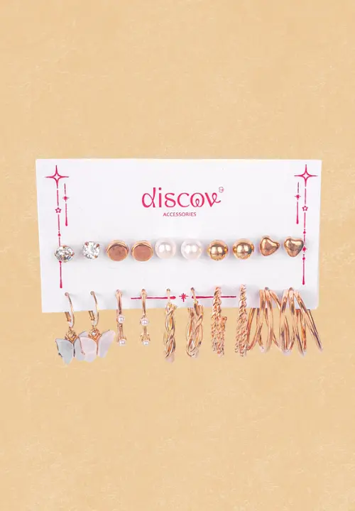 f (4) This collection features multiple pairs of small, gold-toned stud earrings with various feminine designs. The set includes ribbon bows, floral shapes (some with pearls/crystals), crystal clusters, and abstract geometric shapes.