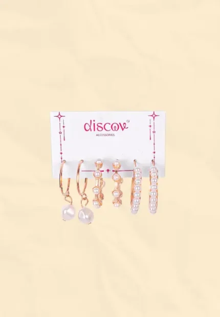 This large gold-toned earring set features a mix of studs and hoops for multi-piercing stacks. It includes delicate butterfly hoops, chunky chain-link hoops, spiral hoops, crystal studs, and pearl studs.