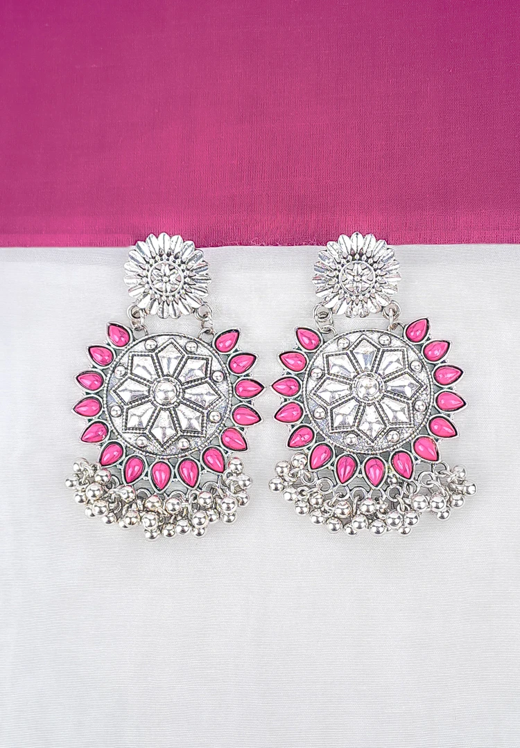 th (12) Large, two-tiered oxidized silver stud earring. The top tier is a floral stud, and the main disc tier features an intricate Mandala or geometric pattern, dramatically framed by an outer border of magenta enameled teardrop shapes with small metallic beads dangling below.