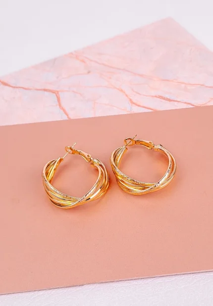 Minimalist twisted hoop earrings with polished finish and latch-back closure, designed for a sleek and elegant look.