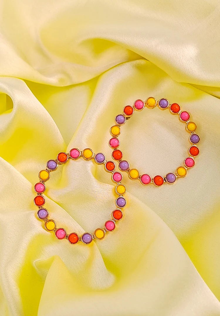 th (16) Multicolor beaded hoop earrings with pink, yellow, purple, and orange accents.