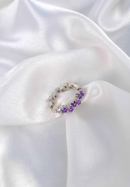 Two geometric silver rings in purple and pink colours.