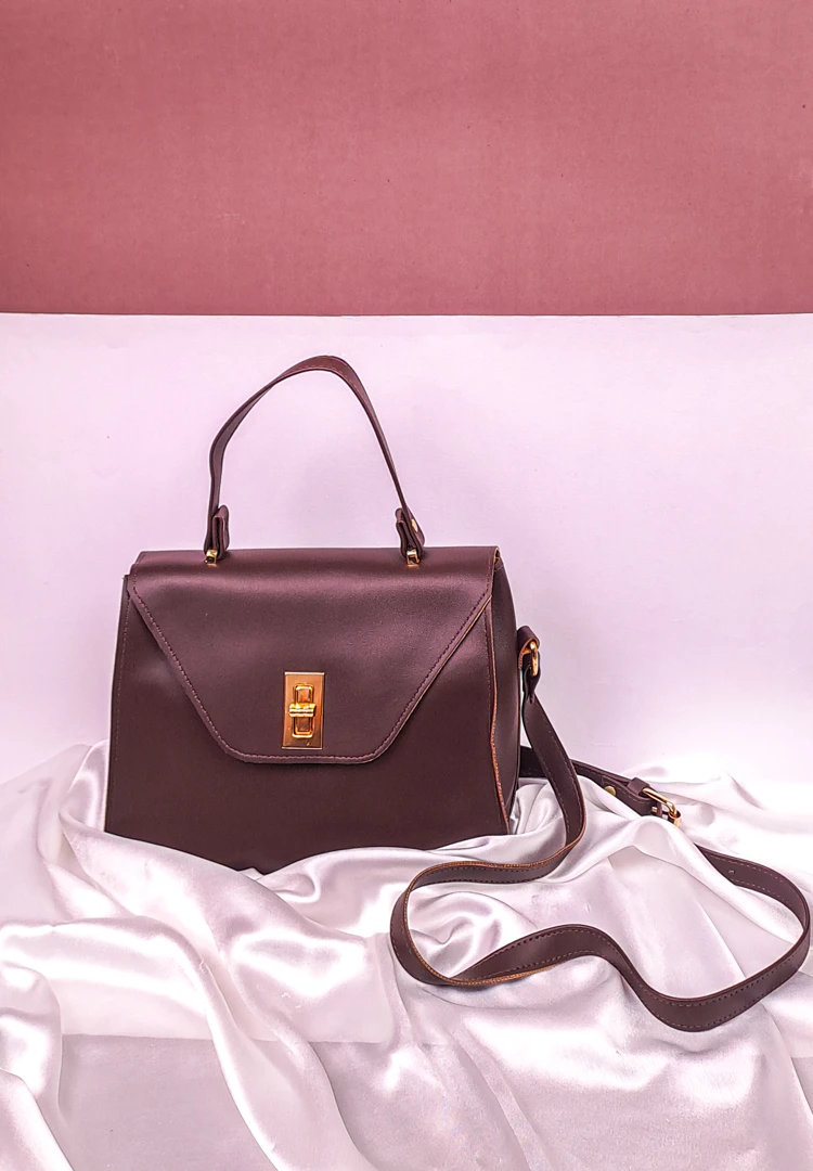 th (33) Brown bag with a gold twist clasp and adjustable strap, perfect for everyday wear — elegant and minimal design