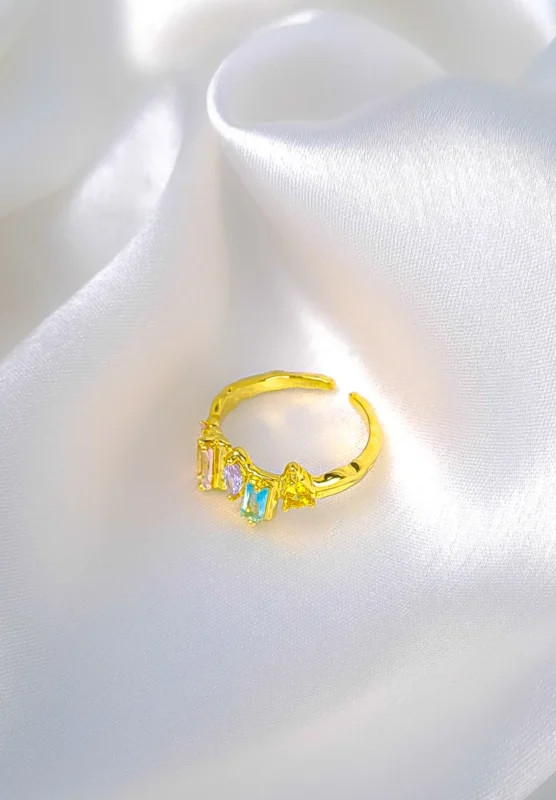 Gold adjustable open ring with pastel baguette crystals.