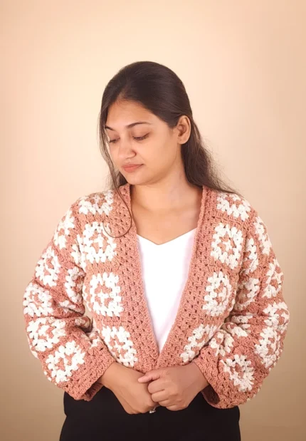 Women’s crochet patchwork cardigan featuring soft pastel panels and a handmade finish.