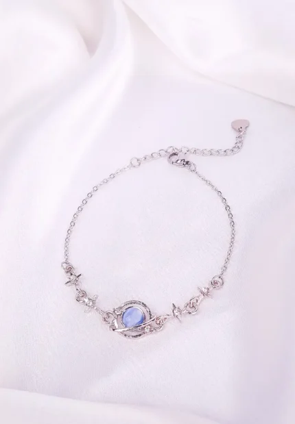 Silver-tone bracelet with blue oval stone and crystals, fine chain and secure clasp.