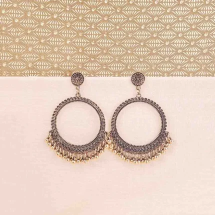 Oxidized golden Chandbali earrings with crescent-shaped hoops, ghungroo detailing, and floral stud top, perfect for festive occasions and weddings.